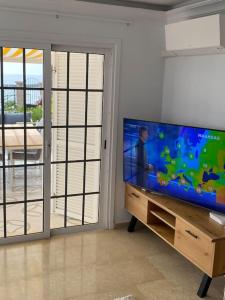 阿德耶Villa Tranquila, Playa del Duque的客厅配有大屏幕平面电视