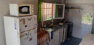 福尔摩沙La Chiqui - Quinta - Alquiler Temporario的厨房配有冰箱上方的微波炉