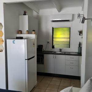 耐莉湾Island Serenity on Magnetic Island的厨房配有白色冰箱和窗户。