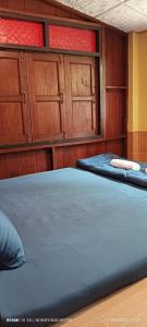 湄宏颂Chanmuang guesthouse的配有木柜的客房内的两张床