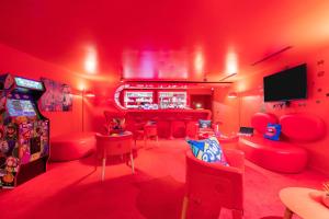 韦利济·维拉库布莱Appart'City Collection Paris Vélizy的红色的房间,设有红色椅子和酒吧