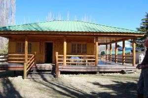 波特雷里约斯Cabaña Familiar El Refugio的一个带绿色屋顶的大型木制凉亭