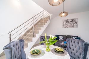 默克斯卡Apartment Olive 2的一间带桌椅和楼梯的用餐室