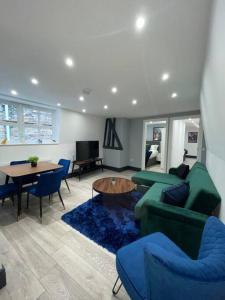亨廷登Abacus House - TWO Bedroom Apartment的客厅配有绿色沙发和桌子