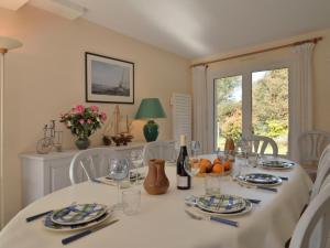 拉蒂尔巴勒Holiday Home Les Chênes Verts - LTB310 by Interhome的用餐室配有带白色椅子的桌子和窗户