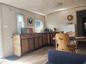 Raon-sur-PlaineChalet Notcimick的厨房配有木制橱柜、桌子和冰箱。