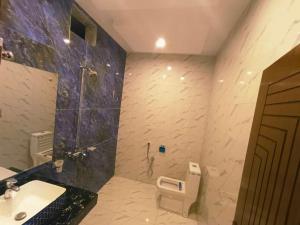 木尔坦The Signature Hotel Multan的带淋浴、盥洗盆和卫生间的浴室