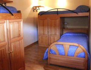 巴尼奥斯德蒙特迈奥尔Albergue Turístico Via de la Plata的一间卧室配有双层床和木制橱柜
