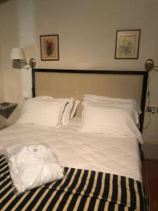 克利通诺河畔坎佩洛Albergo Le Casaline的一张配有白色床单和枕头的大床