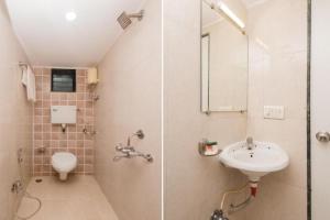 孟买KALPANA RESIDENCY - Near US Embassy的带淋浴、盥洗盆和卫生间的浴室