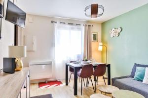 莱萨布勒-多洛讷Appartement cosy, idéalement situé en centre-ville的客厅配有桌椅和沙发
