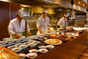 松岛町Ooedo Onsen Monogatari Premium Hotel Sokan的一群厨师在厨房里准备食物