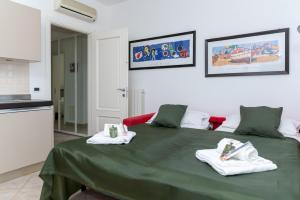 阿拉西奥L'Ulivo di Cecilia的一间设有绿床和毛巾的客房
