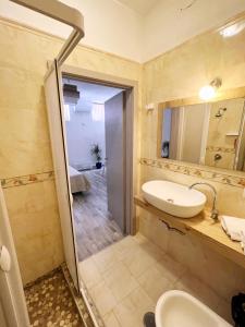 蓬扎Camere Dieci Maggio的一间带水槽、卫生间和镜子的浴室