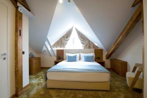 贝尔格莱德萨沃伊城市酒店的阁楼上的卧室配有一张大床