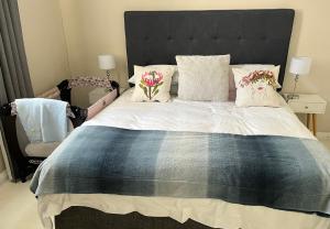 开普敦Seapoint Gem的一间卧室配有一张带鲜花的大床
