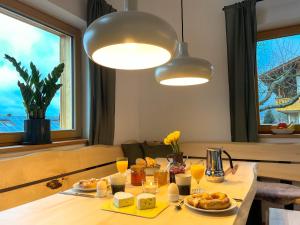 阿尔恩布鲁克Bayerwald Chalet Kaitersberg mit Sauna, Sonnenterrasse und Garten的餐桌,带食物盘和橙汁杯