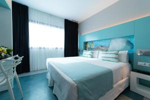 大加那利岛拉斯帕尔马斯Sercotel Puerto de la Luz的一间卧室设有一张蓝色墙壁的大床