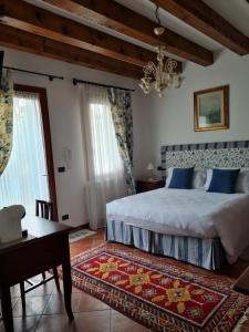 卡瓦利诺Casa Pianta的一间卧室配有一张床、一张桌子和一个吊灯。