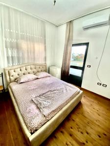 都拉斯Villa Osmani的一间带床的卧室,位于带窗户的房间内