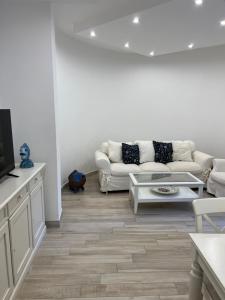 伊斯基亚Maison Mele Ischia的带沙发和电视的白色客厅