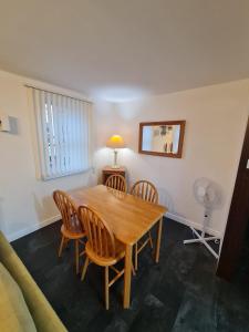 阿尔弗斯顿3 bedroom apartment in Ulverston Cumbria的一间带木桌和椅子的用餐室