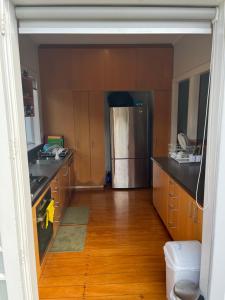 奥克兰Bayswater Homestay的厨房配有不锈钢冰箱和木制橱柜