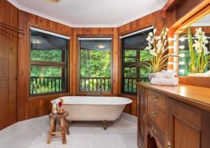 NinderryThe Forest Buré - Fijian Hinterland Retreat的一间带白色浴缸和窗户的浴室
