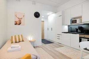埃斯波Forenom Serviced Apartments Espoo Saunalahti的一间白色的厨房,在房间内配有一张床