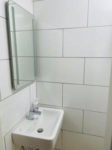 杜伊斯堡Andefu Hotel am Kantpark的白色的浴室设有水槽和镜子