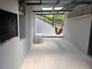 Los Altos de Cerro AzulCasa de campo en Panamá的走廊上设有楼梯和椅子的房间