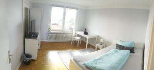 KronshagenFerienwohnung in Kronshagen Monteurwohnung 3 Zimmer 70 m2, Küche und Badezimmer的白色的客厅配有床和书桌