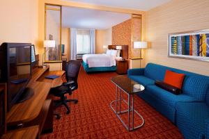 休斯顿休斯敦霍比机场费尔菲尔德套房酒店 的酒店客房配有蓝色的沙发和床。