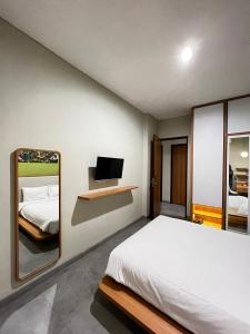 雅加达CASA CALMA HOTEL的一间卧室配有一张床和镜子
