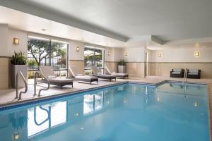 奥斯汀南奥斯丁春季山丘套房酒店的一座配有桌椅的酒店游泳池
