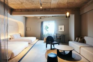 金泽Korinkyo的酒店客房设有两张床和一张桌子。