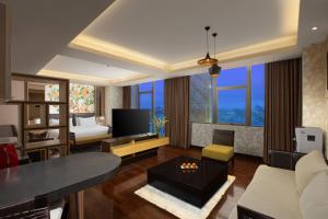 日惹Harper Malioboro Yogyakarta by ASTON的客厅配有沙发和桌子