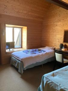 高山Oyado Raku的一间卧室设有两张床和窗户。