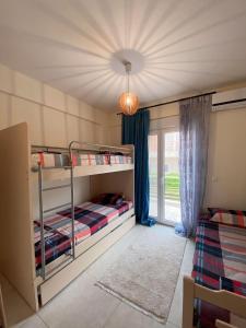 诺亚福克VILLA VARVAKIS的一间卧室设有两张双层床和一扇窗户。