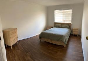Country retreat的一间卧室配有一张床、一个梳妆台和一扇窗户。