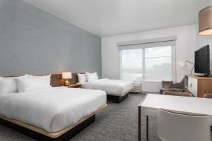 奥兰多TownePlace Suites By Marriott Orlando Southwest Near Universal的酒店客房设有两张床和一台平面电视。