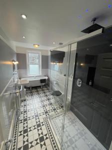 斯沃尼奇Rivendell Guest House的带淋浴和盥洗盆的浴室