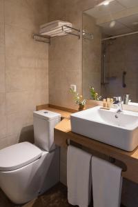 波蒂纳茨拉斯归纳旅馆的浴室配有白色卫生间和盥洗盆。