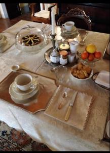 拉波拉诺泰尔梅宫比扎里旅馆的桌子上放有盘子,杯子和碗的食物
