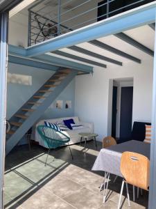 奥雷龙圣但尼Maison contemporaine Oléron的客厅设有蓝色的楼梯和沙发