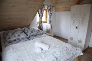 米卢夫卡Beskidzka Chałupa的一间卧室配有一张床,上面有两条毛巾