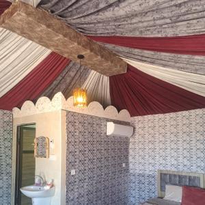 瓦迪拉姆Dream Bedouin life camp的浴室拥有红色和白色的天花板和水槽