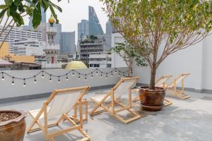 曼谷Chocolate box mint - SHA Plus的屋顶上一排椅子和一棵树
