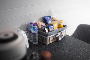 Endrick Escape - Luxury Glamping的柜台上的一篮子食物和瓶装水