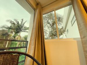 圣罗莎德卡瓦尔Hotel Campestre Villa Mary的带窗帘和椅子的窗户的房间